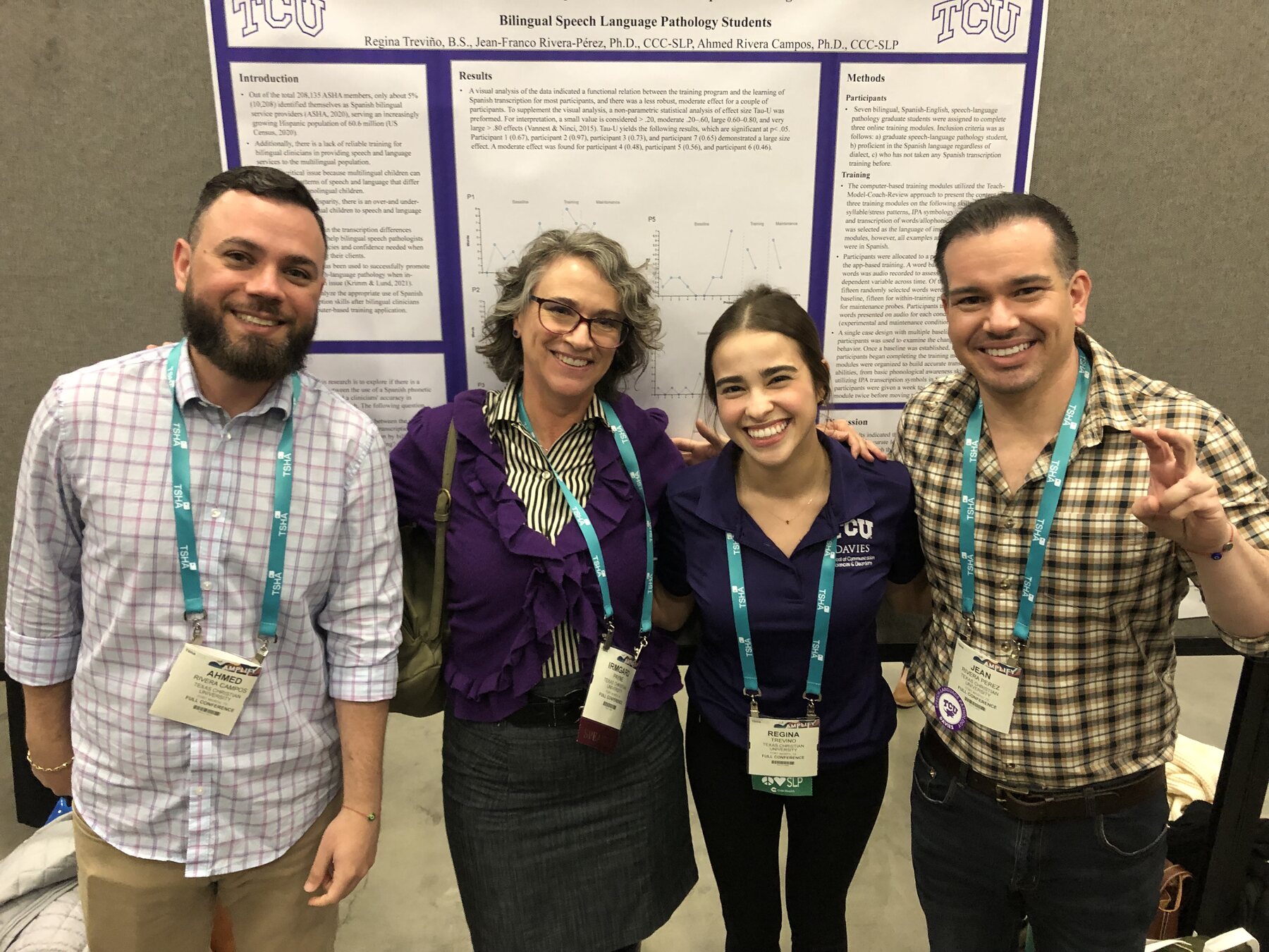 BEAR Lab collaborators standing together in front of a bilingual research poster