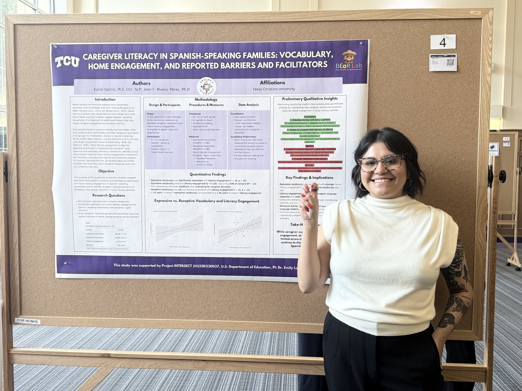 A student researcher presenting a poster about caregiver literacy and Spanish-speaking families