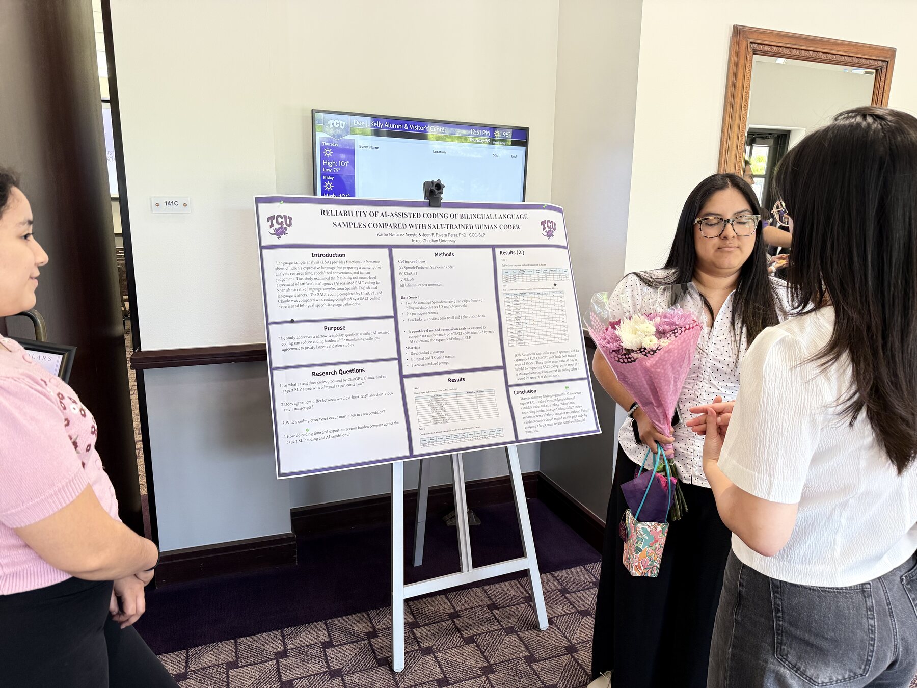 Students discussing a research poster about AI-assisted coding of bilingual language samples